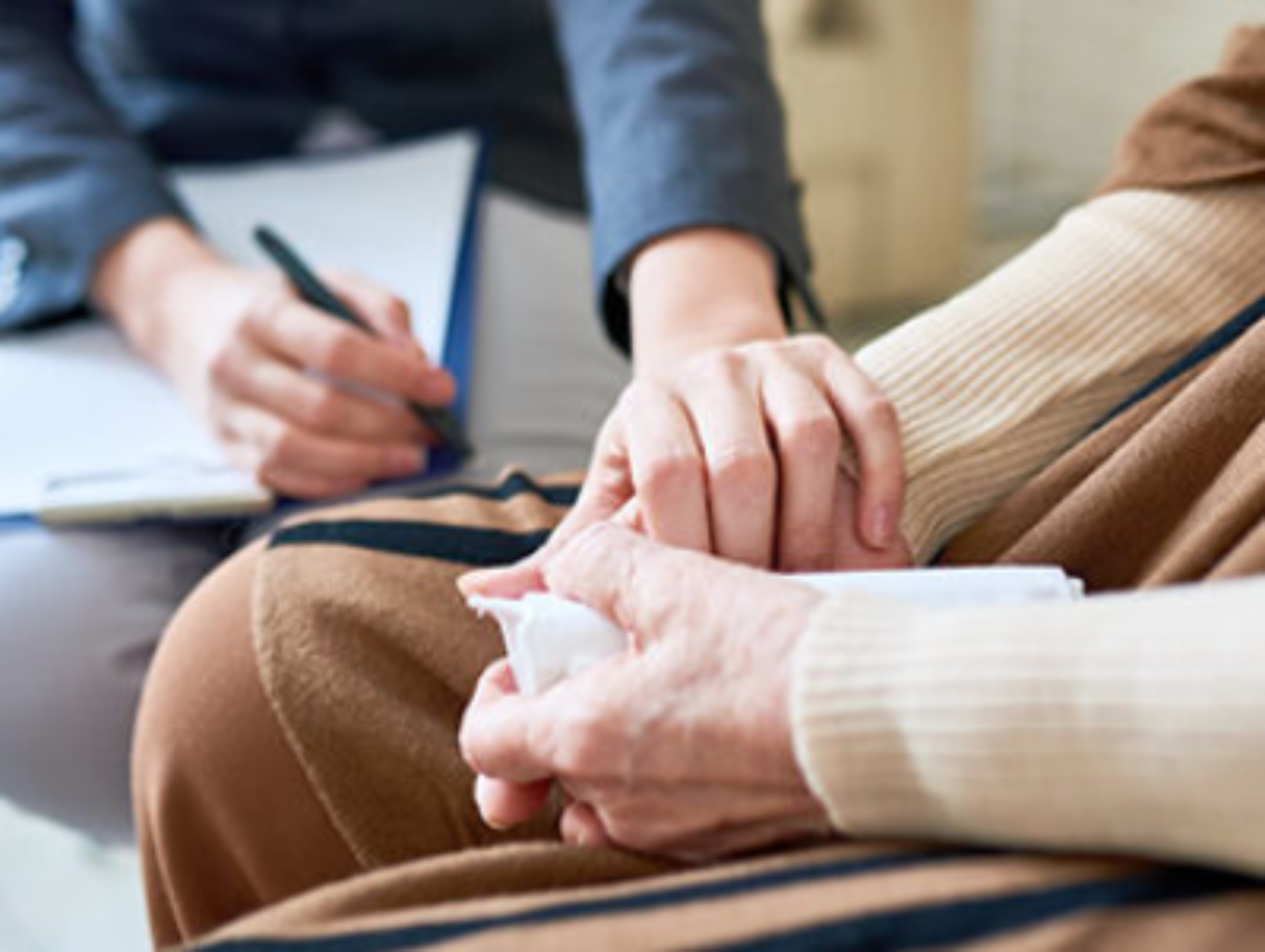Psychologist holding the hands of a senior woman during a therapy session | Victoria Wellness Mental Health Treatment Centre, Gores Landing, near Toronto, Ontario